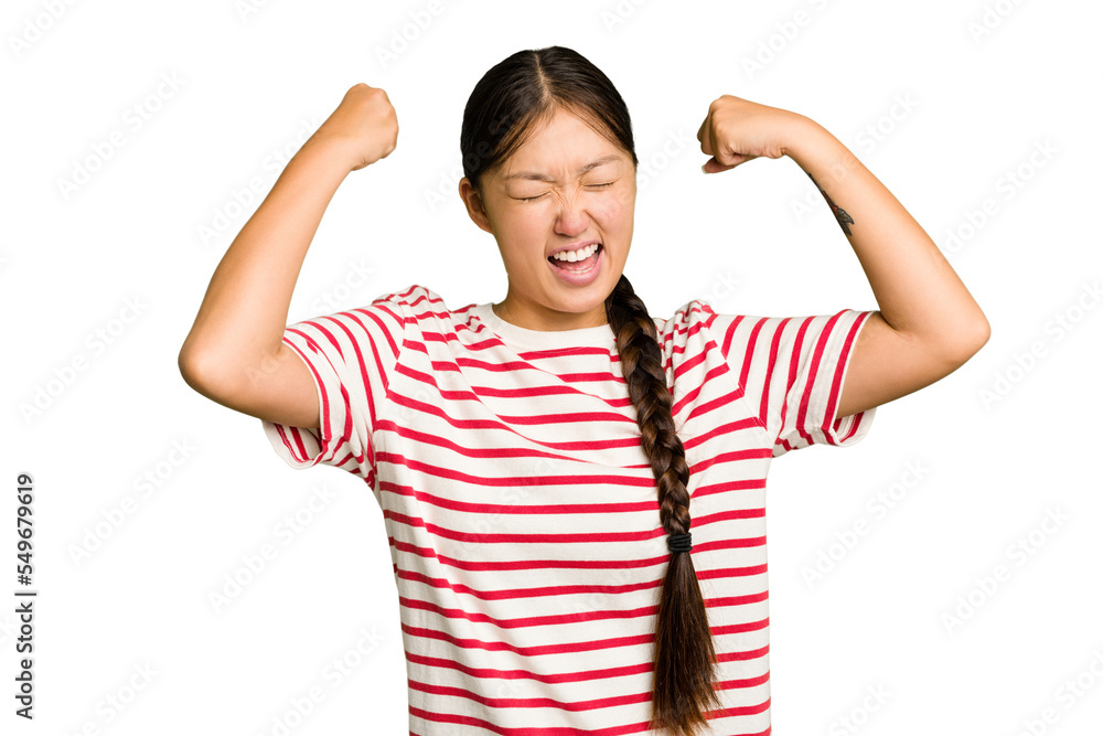 Wall mural Young Asian woman isolated raising fist after a victory, winner concept.