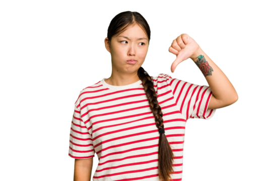 Young Asian woman isolated showing a dislike gesture, thumbs down. Disagreement concept.