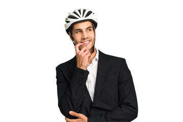 Business Caucasian man wearing a bike helmet isolated relaxed thinking about something looking at a copy space.