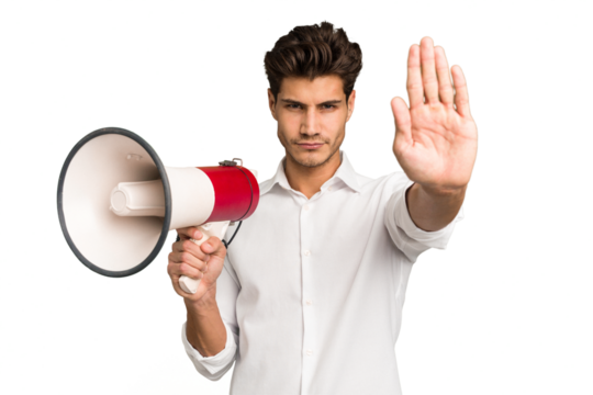 Young caucasian man holding megaphone isolated standing with outstretched hand showing stop sign, preventing you.
