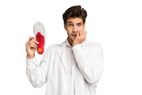 Young caucasian chiropodist man isolated biting fingernails, nervous and very anxious.