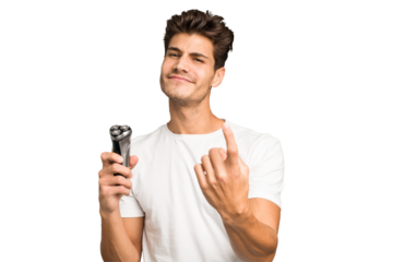 Young caucasian man holding a razor isolated pointing with finger at you as if inviting come closer.