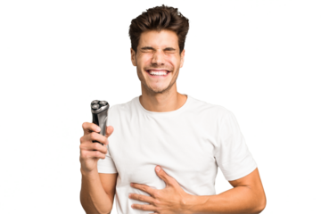 Young caucasian man holding a razor isolated laughing and having fun.