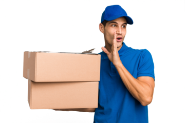 Young delivery caucasian man holding boxes isolated is saying a secret hot braking news and looking aside