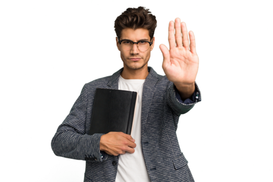 Young teacher caucasian man holding a book isolated standing with outstretched hand showing stop sign, preventing you.