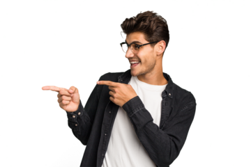 Young caucasian handsome man isolated points with thumb finger away, laughing and carefree.