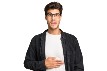 Young caucasian handsome man isolated touches tummy, smiles gently, eating and satisfaction concept.