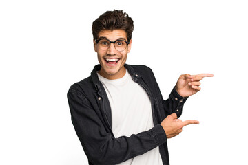 Young caucasian handsome man isolated excited pointing with forefingers away.