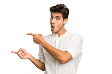 Young caucasian handsome man isolated pointing with forefingers to a copy space, expressing excitement and desire.