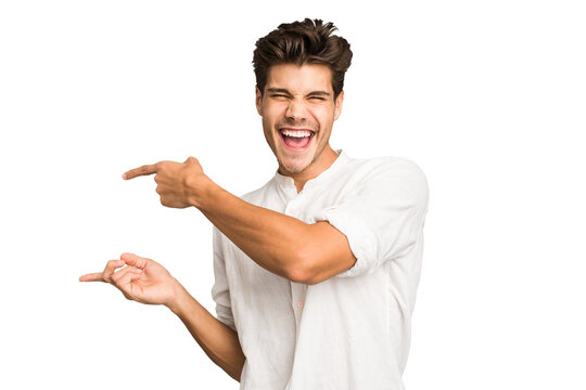 Young caucasian handsome man isolated excited pointing with forefingers away.
