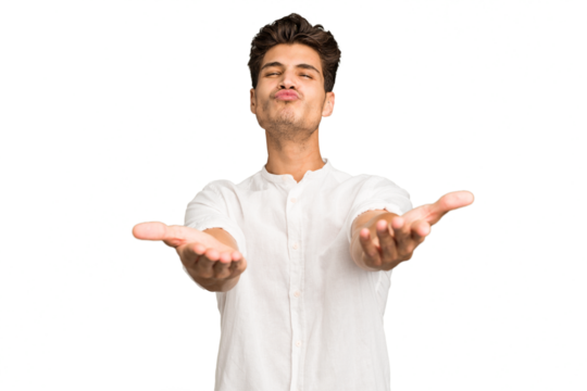 Young caucasian handsome man isolated folding lips and holding palms to send air kiss.