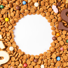 Dutch holiday Sinterklaas background with copy space fot text. Kruidnoten cookies and traditional hollands sweets. Concept for children party Saint Nicolas day five december. Top view, overhead.