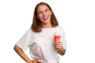 Young caucasian woman holding an ice cream isolated laughing and having fun.