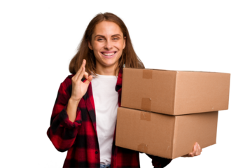 Young caucasian woman moving while picking up a box full of things isolated cheerful and confident showing ok gesture.