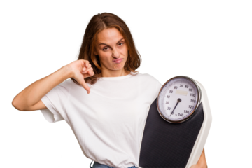 Young caucasian woman holding a scale and measure tape isolated showing a dislike gesture, thumbs down. Disagreement concept.