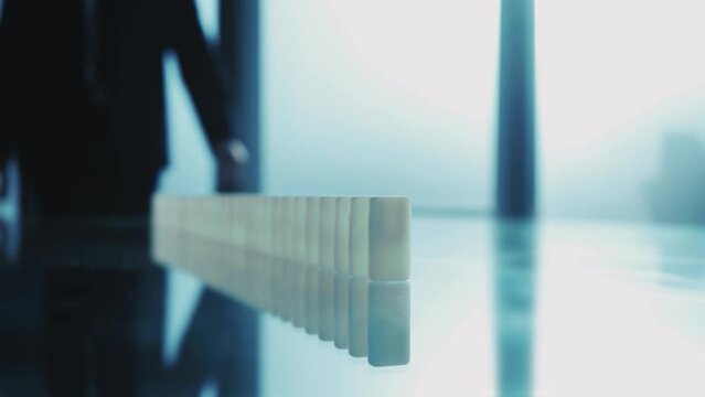 business man pushing domino stones. business concept.