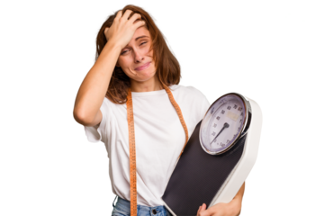 Young nutritionist caucasian woman holding scale and mesure tape isolated