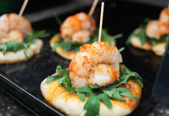 Snacks with shrimps in tapas bar in Spain, traditional Spanish food