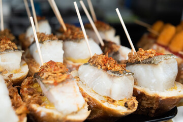 Snacks with cod fish in tapas bar in Spain, traditional Spanish food.