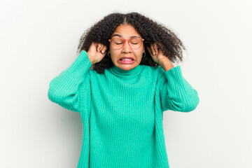 Young african american woman isolated on white background covering ears with hands.