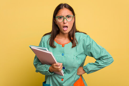 Young child teacher angry asking for silence isolated on yellow background