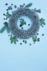 Christmas New Year's wreath of small silver cones on a light blue background. christmas new year concept

