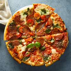 Homemade pizza with sausage and pesto sauce	
