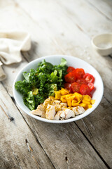 Homemade chicken bowl with mango and kale