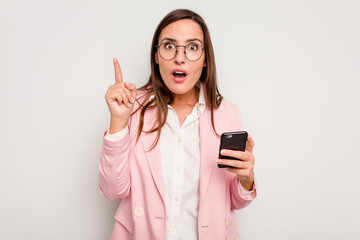 Business caucasian woman holding a mobile phone isolated on white background having an idea, inspiration concept.