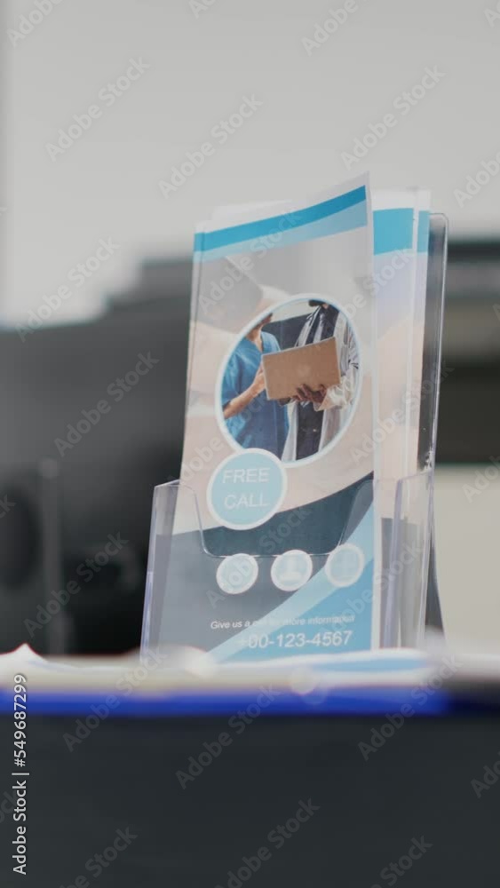 Poster vertical video: empty hospital reception counter with checkup report files used by receptionist and 