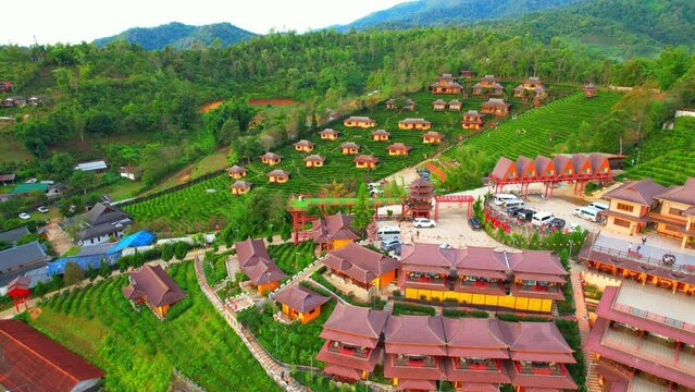 Ban Rak Thai is a small highland village, It is set in a valley surrounded by hills and tea plantations on the edge of a reservoir. Famous tourist attractions in Thailand. aerial view. Drone 4K
