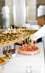 waiter prepare food for a buffet table in a restaurant. catering