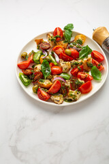 Close up of fresh tomato crouton salad with pesto