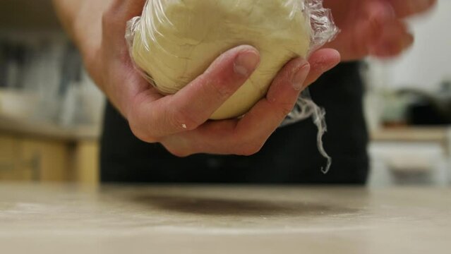Wrapping dough ball to plastic film, handmade cooking