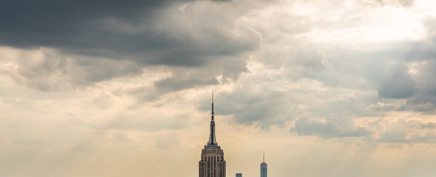 Skyscraper lightning rod on cloudy rainy sky panorama with low hanging clouds