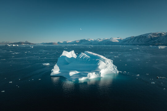 Aerial View Over Floating Iceberg in Remote Greenland