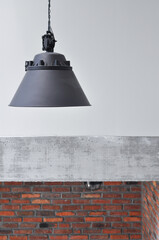 Close up concrete wall, industrial loft  metal old black lamp , black cable on the wall, industrial interior design, copy space, black and cable on top