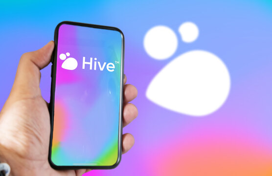 hand holding a phone with Hive Social mobile app on screen