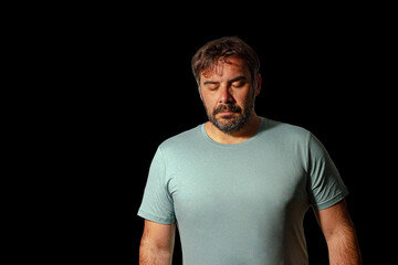 Upset and sad man posing isolated on black background studio portrait.