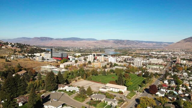 Pleasing Aerial Shot over Downtown Kamloops in the Okanagan in British Columbia on a sunny day with clear sky and the north shore mountains in the background