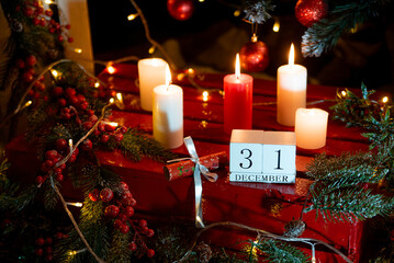 December 31 calendar on the background of a Christmas tree with decor and candles. happy New Year