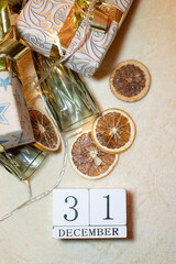 calendar with the date December 31 on a background of oranges, glasses of garland on a beige background. decor christmas
