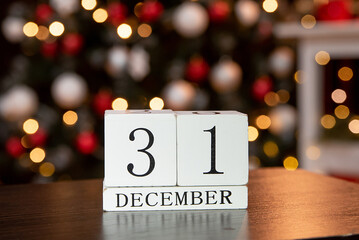 calendar with the date December 31 on the background of candles and Christmas decor in red