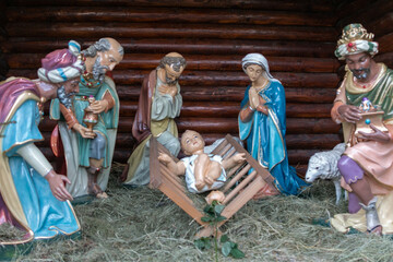 Nativity scene with figurines of Jesus, Mary, Joseph, sheep and wise men.