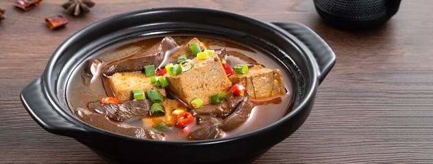 Spicy duck blood jelly soup and stinky tofu with scallion and chili pepper topping.