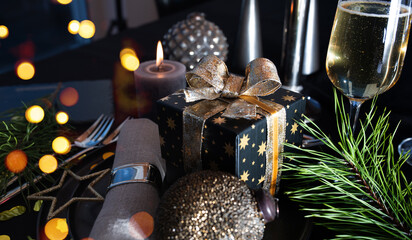 Atmospheric table decoration for a christmas or new year dinner. Place setting in modern style....