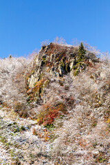 Freshly fallen snow in the mountains. Change of seasons in the mountains. Frosty autumn in the mountains. Features of nature in the mountains. The beginning of winter in the mountains.