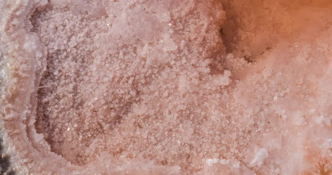 Closeup detailed shot of unrefined salt in Salt lake in Tunisia Chott el Djerid red color of water from the salt minerals. Largest salt lake in the Sahara Desert.