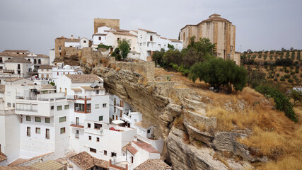 Aerial drone view of the village Setenil de las Bodegas, known for its whitewashed houses built into the surrounding cliffs. Touristic destination. Holidays and vacation. Travel the world. 