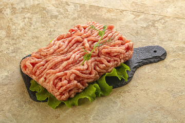 Raw minced pork meat over board